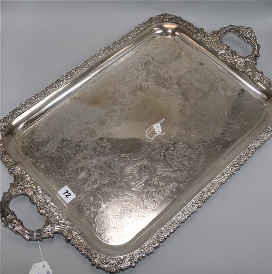 A large plated twin-handled rectangular tray, engraved, with foliate-cast edges